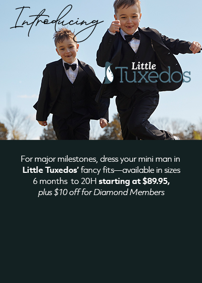 Two boys playing in field with tuxedos