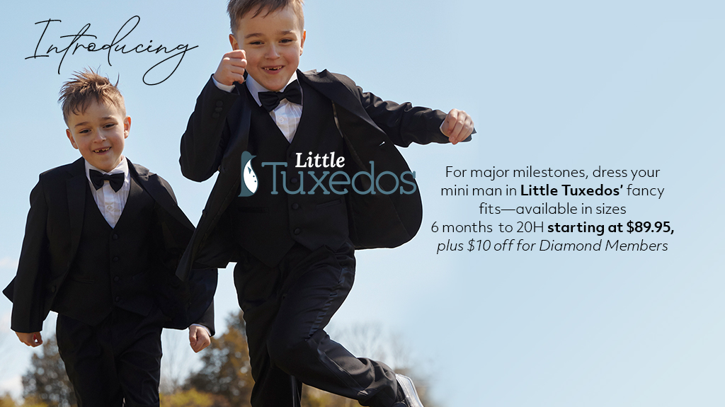 Two boys playing in field with tuxedos