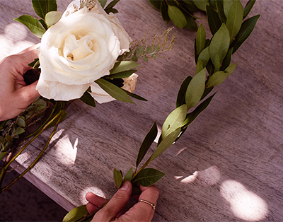 Woman Arranging a Simple Flower Bouquet | David's Bridal