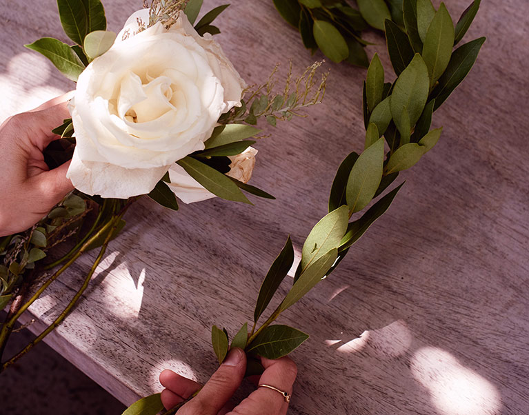 Woman Arranging a Simple Flower Bouquet | David's Bridal